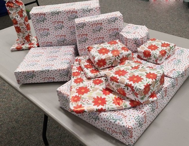 Gift boxes wrapped in festive holiday paper.